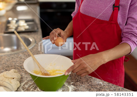Woman making Christmas cookies 58143351