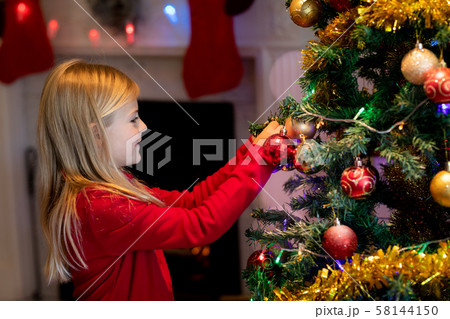 Girl at home at Christmas time Girl at home at Christmas time 58144150
