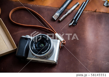 Mirrorless vintage camera with leather strap and 58145551
