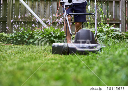 lawn mower is old in a private house, mowing the grass lawn mower is old in a private house, mowing the grass 58145673