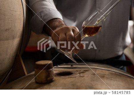 wooden barrel on a dark background, in a workshop wooden barrel on a dark background, in a workshop 58145785