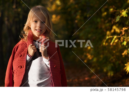 Cute little girl playing in the autumn park. Cute little girl playing in the autumn park. 58145798