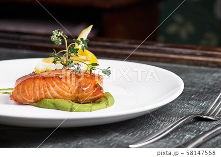Grilled salmon with vegetables served on a plate Grilled salmon with vegetables served on a plate 58147568