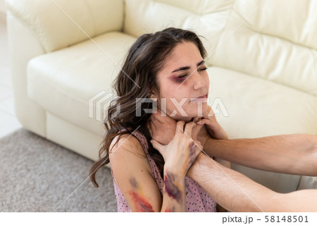 Victim, abuse and domestic violence - Woman being abused and strangled by strong man Victim, abuse and domestic violence - Woman being abused and strangled by strong man 58148501