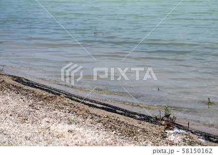 The beach is contaminated with oil from the boat. 58150162