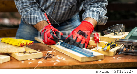 Craftsman at work on wooden boards. Carpentry. 58151227