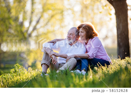 Beautiful senior couple in love outside in spring nature, hugging. Beautiful senior couple in love outside in spring nature, hugging. 58152628