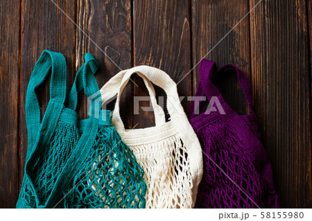 Variety colors of cotton eco mesh bag on the table Variety colors of cotton eco mesh bag on the table 58155980