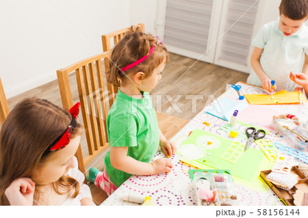 Little children make lovely postcards at a workshop 58156144