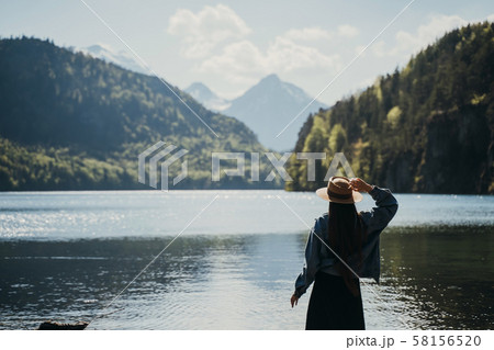The girl in the dress and hat of the lake in the mountains The girl in the dress and hat of the lake in the mountains 58156520
