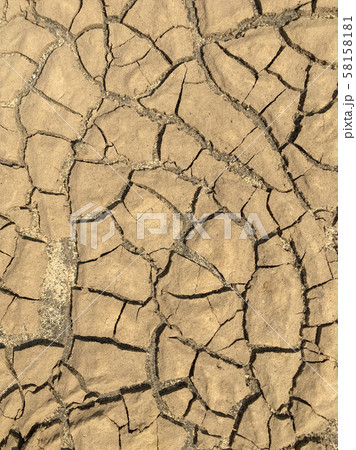 Top view closeup weathered texture and background of arid cracked ground. Broken dried mud from arid problem. Global warming crisis. Agricultural land without water. Climate change. 58158181