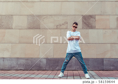 Male athlete, guy dancer in summer city. Free space for motivation text. Fashionable modern break 58159644