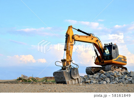 Excavator with crusher bucket for crushing concrete. Excavator with crusher bucket for crushing concrete. 58161849