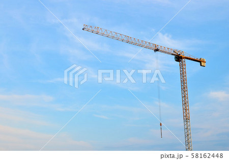 Jib construction tower cranes at a construction site on the blue sky background  58162448