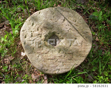 Millstone in woodland Millstone in woodland 58162631