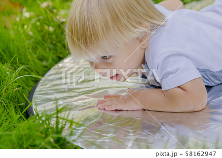 Happy little boy on a green lawn in a park. Happy little boy on a green lawn in a park. 58162947