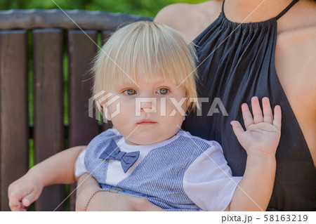 Beautiful young mother with a little son on a Beautiful young mother with a little son on a 58163219