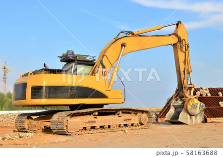 Excavator with crusher bucket for crushing concrete. Construction waste recycling  58163688