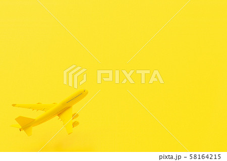 Airplane flying on yellow background. 58164215