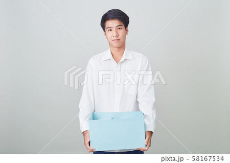 Young asian businessman holding a box 58167534