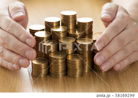 積み上げた金貨と手 積み上げた金貨と手 58169299