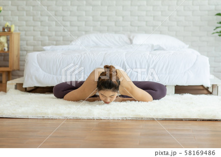 Happy Attractive Asian woman practice yoga baddha konasana pose with meditation smile with big belly after wake up in the morning Feeling so comfortable and relax,Healthcare Concept Happy Attractive Asian woman practice yoga baddha konasana pose with meditation smile with big belly after wake up in the morning Feeling so comfortable and relax,Healthcare Concept 58169486