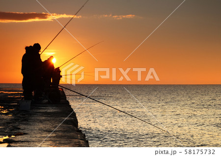 Fishermen at sunrise on the sea Fishermen at sunrise on the sea 58175732