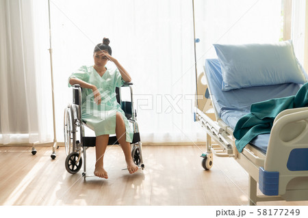 Serious patient sitting on wheelchair in hospital. Serious patient sitting on wheelchair in hospital. 58177249