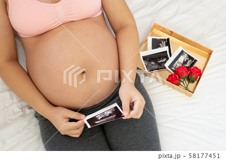Happy pregnant woman and expecting baby at home. Happy pregnant woman and expecting baby at home. 58177451