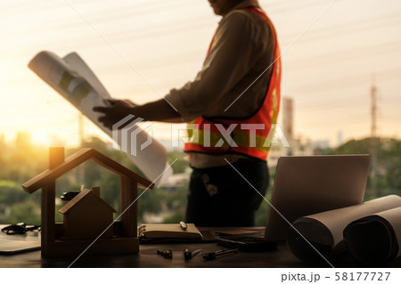 Young man architect or engineer working at desk. 58177727
