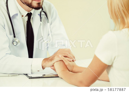Male Doctor and Female Patient in Hospital Office 58177887