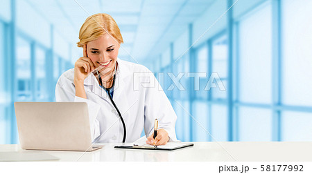 Doctor using laptop computer at the hospital. 58177992