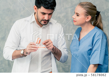 Dentist and nurse working in dental office. Dentist and nurse working in dental office. 58178062