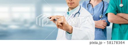 Doctor working in hospital with other doctors. Doctor working in hospital with other doctors. 58178364