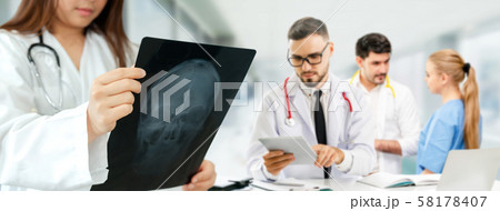Doctor working in hospital with other doctors. 58178407