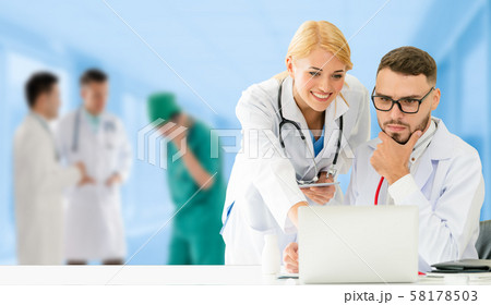 Doctor working in hospital with other doctors. 58178503