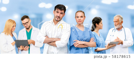 Doctor working in hospital with other doctors. 58178615