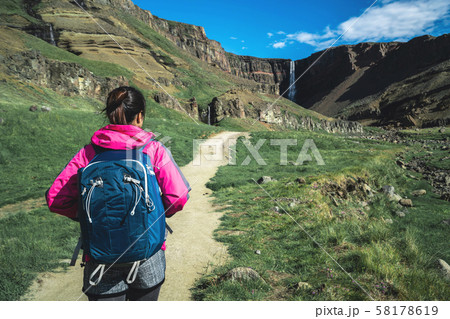 Traveler hiking at Hengifoss Waterfall, Iceland. 58178619
