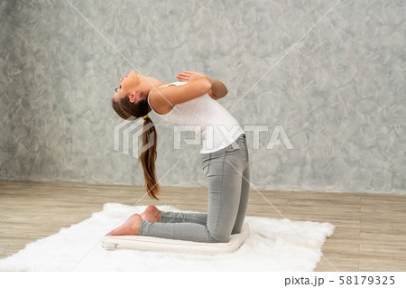 Young woman yoga on carpet at home living room. 58179325