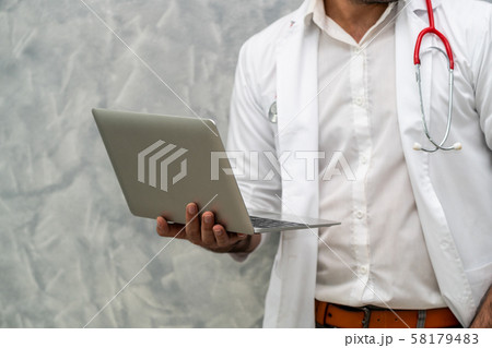 Doctor using laptop computer at the hospital. 58179483