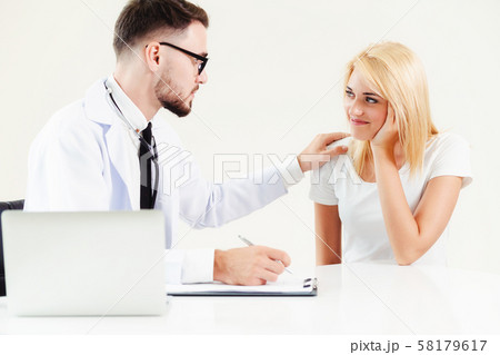 Male Doctor and Female Patient in Hospital Office 58179617