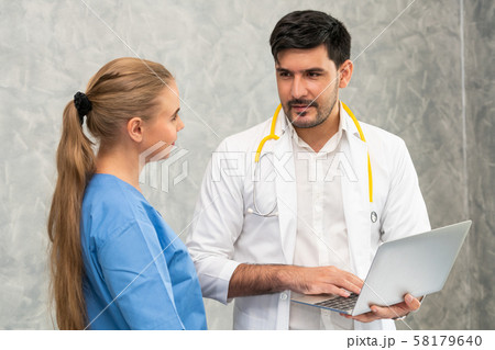 Doctor and nurse working with laptop computer. 58179640