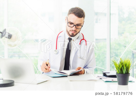 Doctor working on laptop computer hospital. 58179776