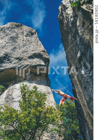 Man climbing a rock.  58180902