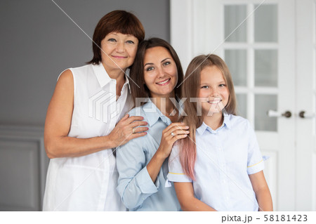 Daughter, mother and grandmother stand closeto each other and hugging Daughter, mother and grandmother stand closeto each other and hugging 58181423