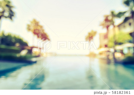 Blur summer background for resort hotel pool party with blue cool sky and tropical palm tree 58182361