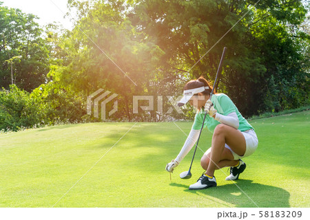 Healthy Sport.  Asian sporty woman putting golf ball 58183209