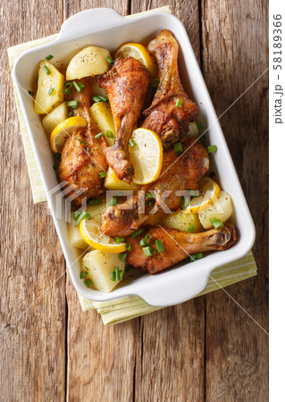 Chicken legs with lemon and boiled potatoes in 58189366
