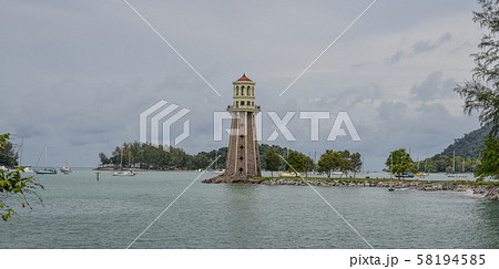Stone lighthouse with the blue sea 58194585