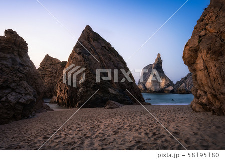 Impressive Ursa Beach with unique rock lit by golden sunset evening light. Located near Cabo da Roca Impressive Ursa Beach with unique rock lit by golden sunset evening light. Located near Cabo da Roca 58195180